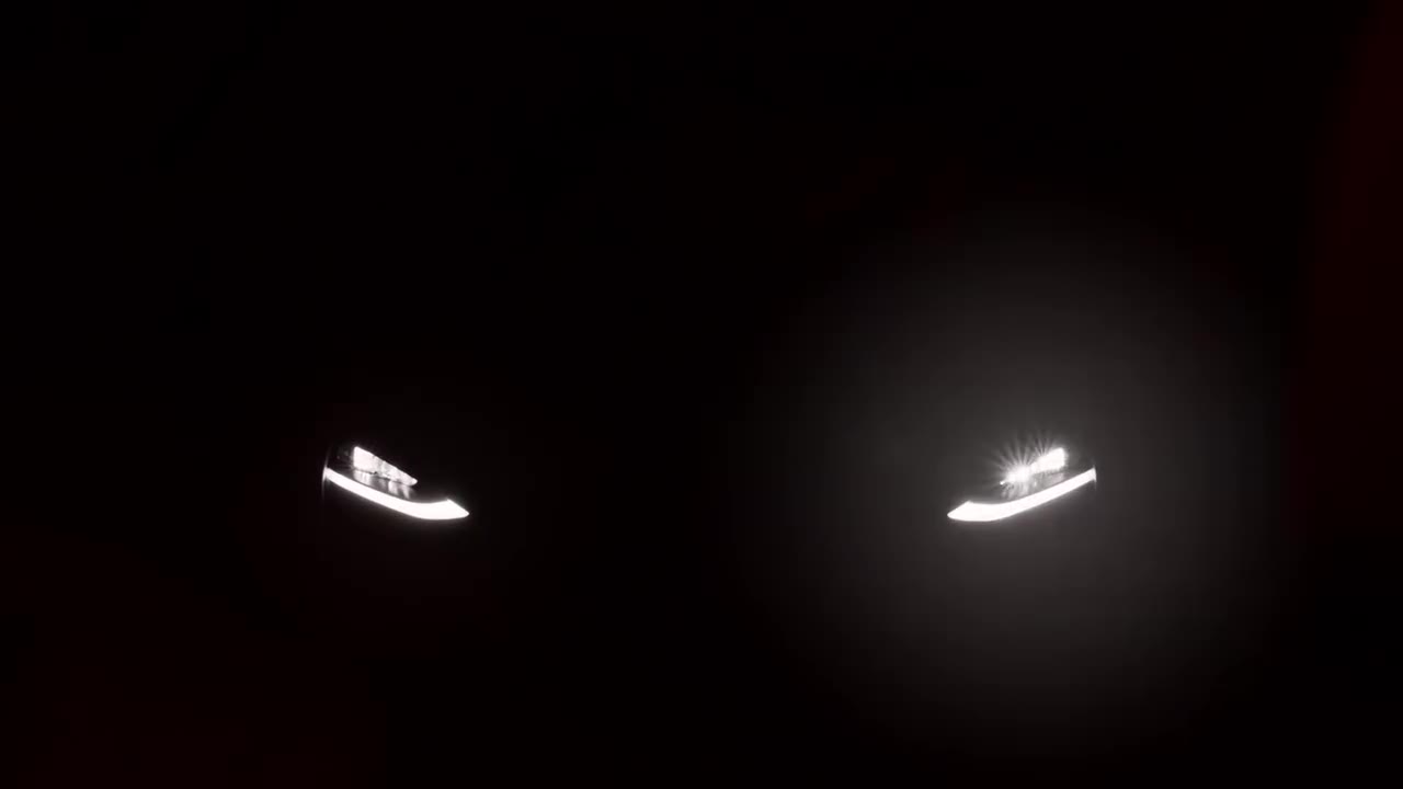 McLaren headlights glinting in darkness