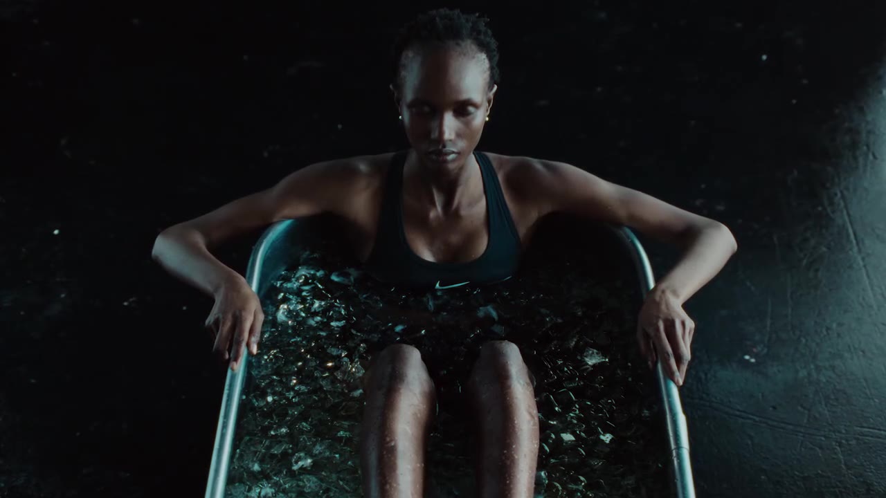 Athlete seated in dramatic hard key light